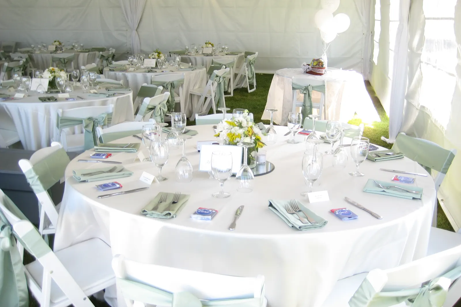 Elegant banquet table setup with white chiavari chairs and floral centerpieces at an outdoor event in El Paso TX by Sweet n' Sassy Creations