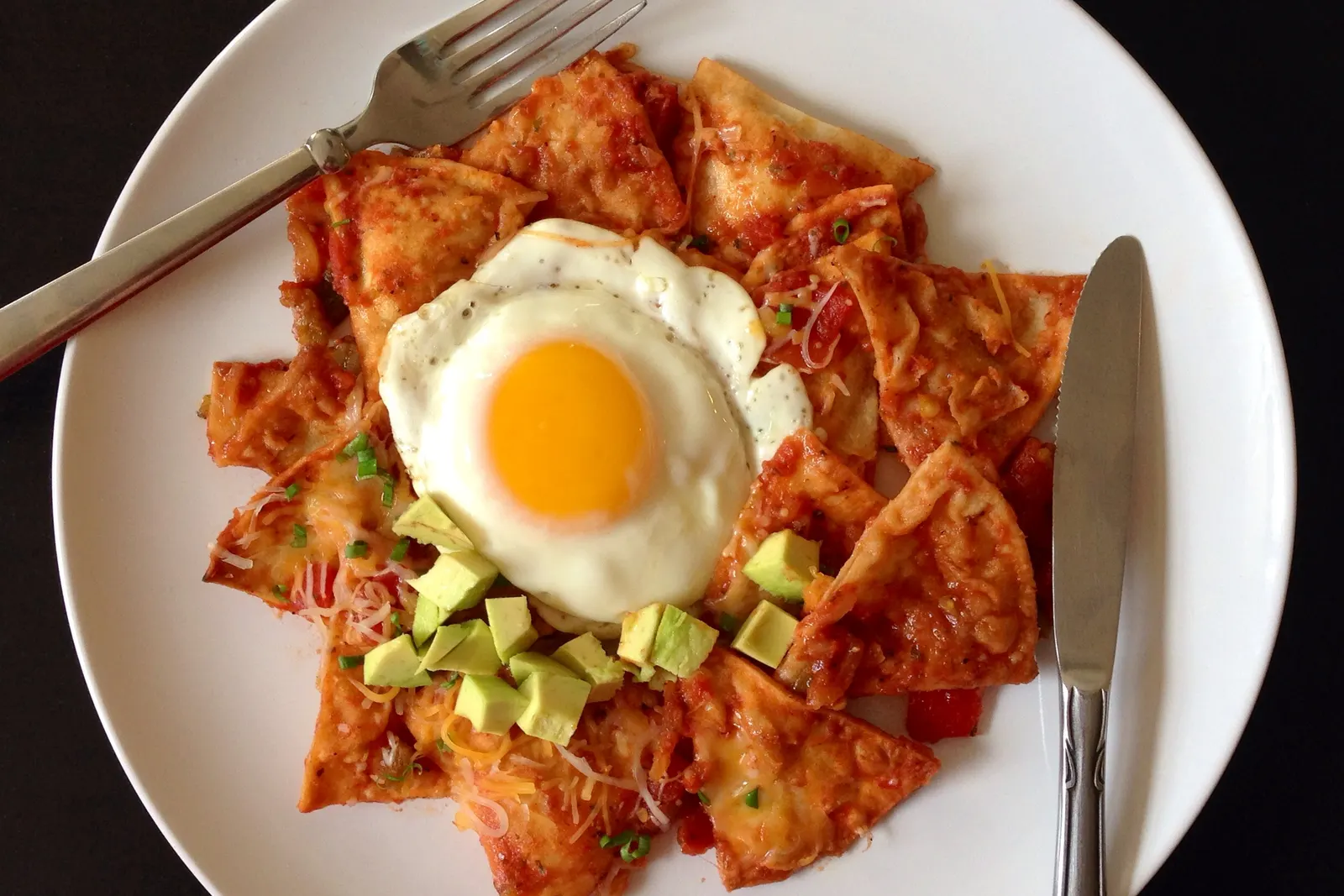 Vibrant homemade chilaquiles bar with crispy tortilla chips in red and green salsa at a Sweet n' Sassy Creations brunch event near El Paso International Airport, El Paso TX