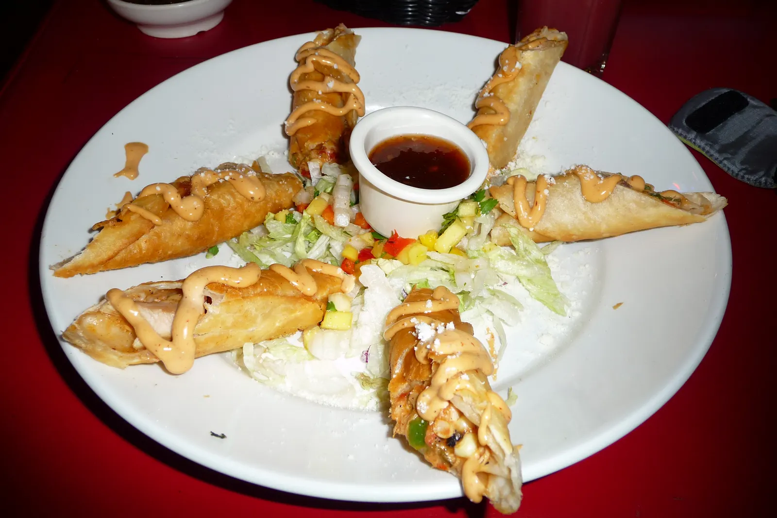 Golden crispy homemade flautas on a wooden platter with guacamole and salsas at a Sweet n' Sassy Creations quinceañera in Northeast El Paso TX near UTEP