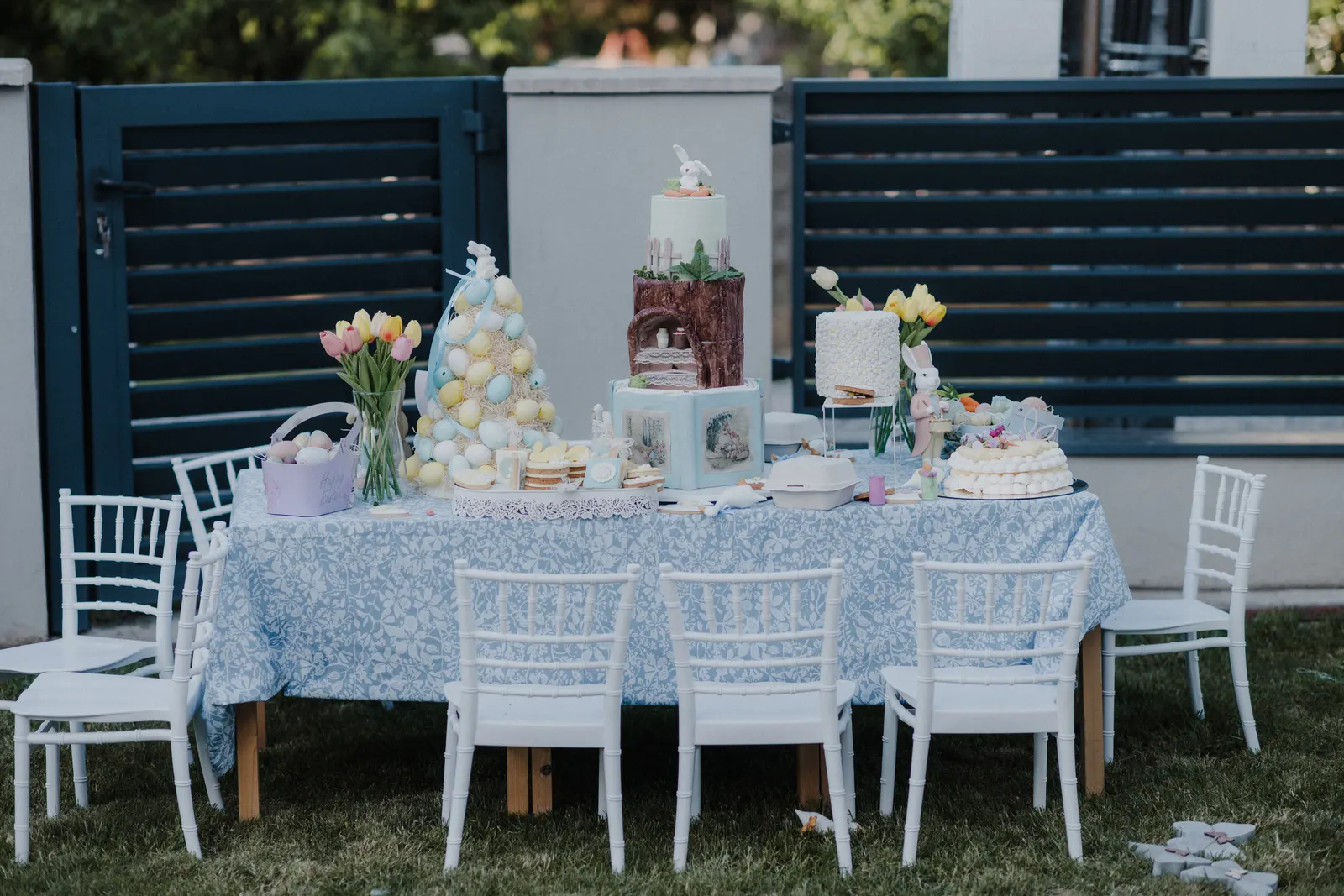 Elegant wedding-style dessert table with blush roses, macarons, champagne, and white wedding cake styled by Sweet n' Sassy Creations El Paso Texas