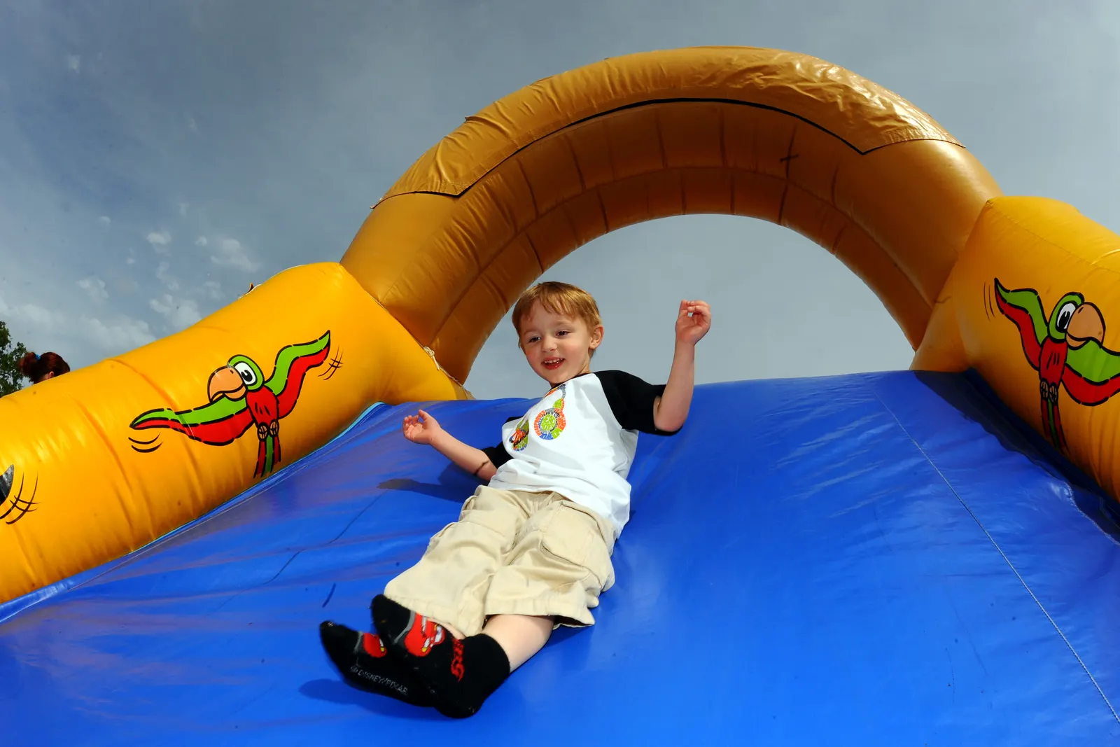 Happy children laughing and jumping inside a colorful inflatable bounce house at a birthday party in El Paso, TX — Sweet n' Sassy Creations bounce house rental